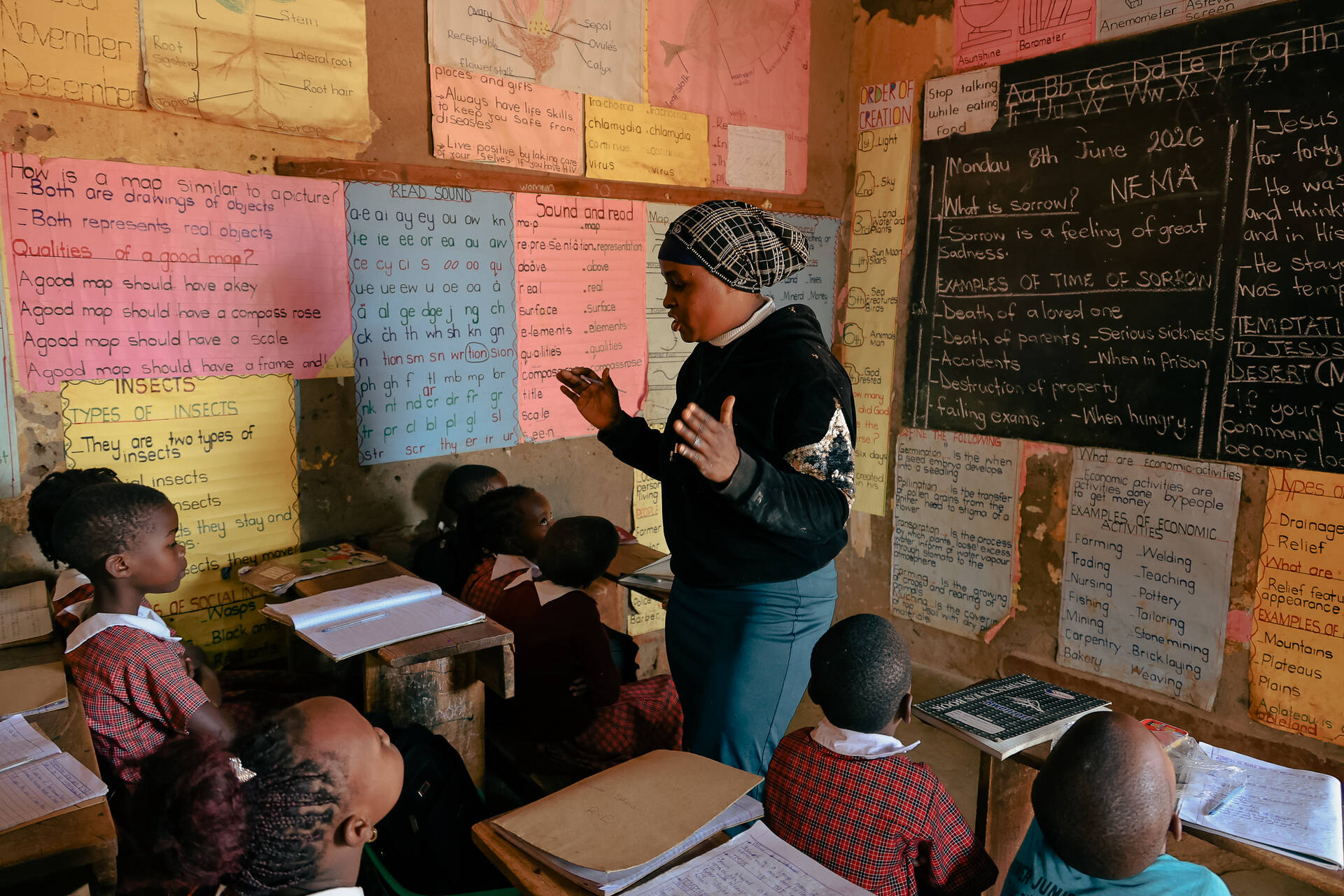 A teacher taking learners through lessons in an Affordable Non-state School. Photo Credit: Jason Amoo/Opportunity International